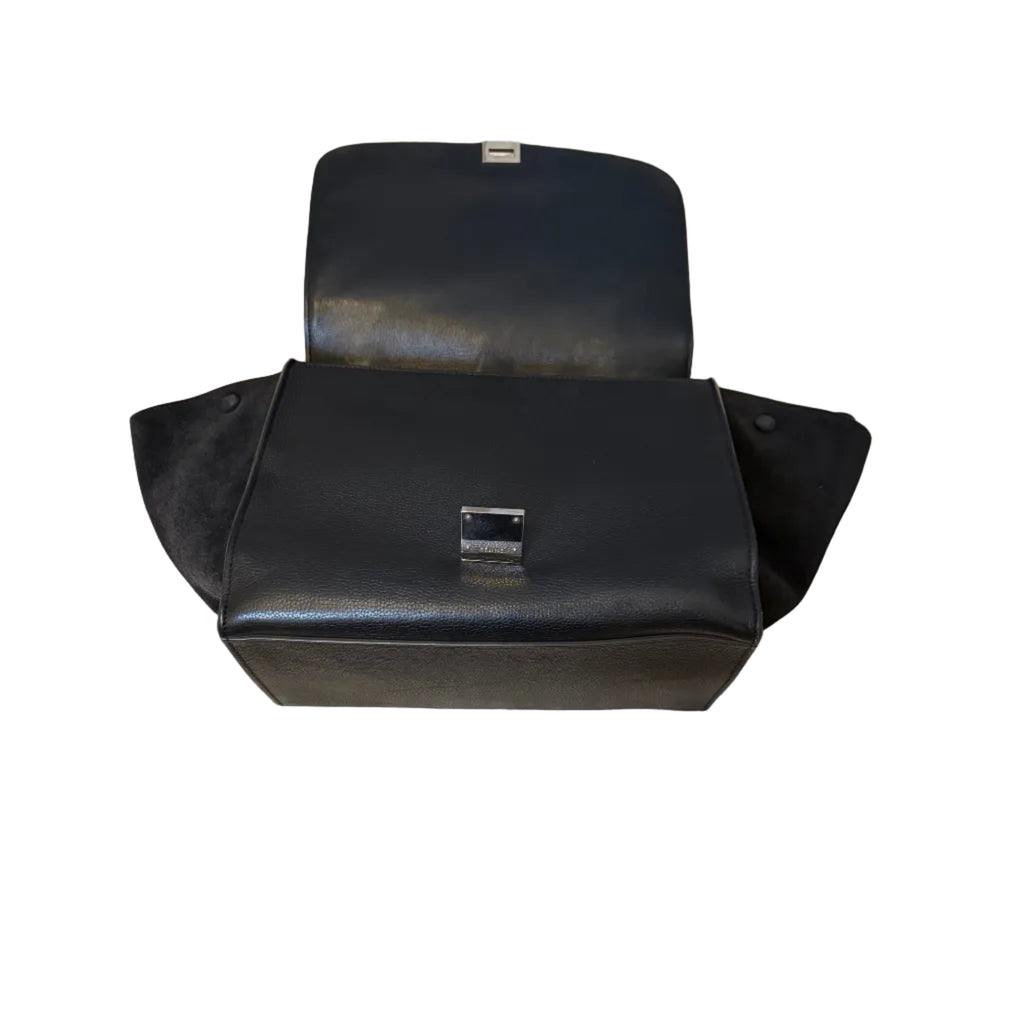 Black leather motorcycle seat with visible stitching on a white background