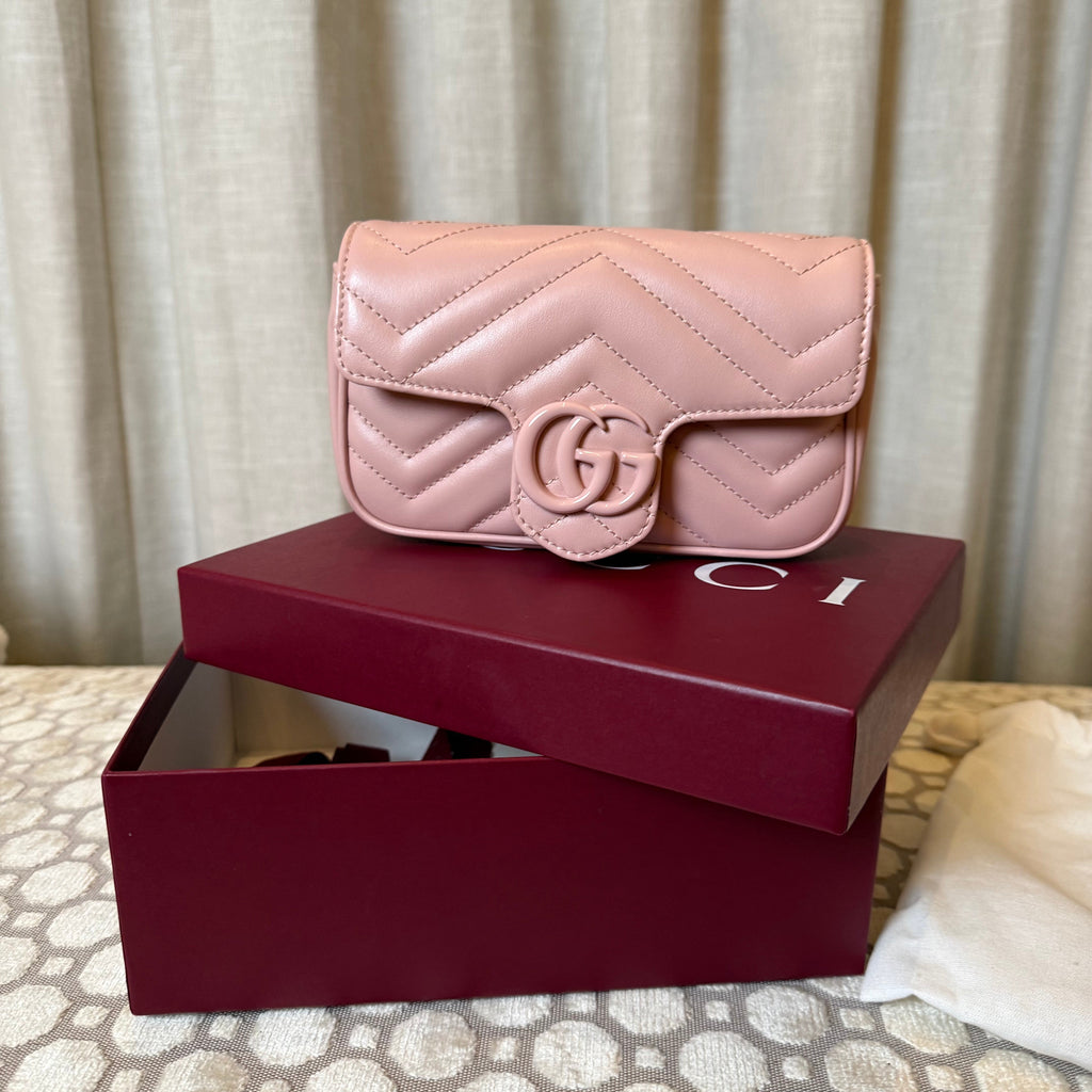 Pink quilted handbag with a visible brand logo on a white background