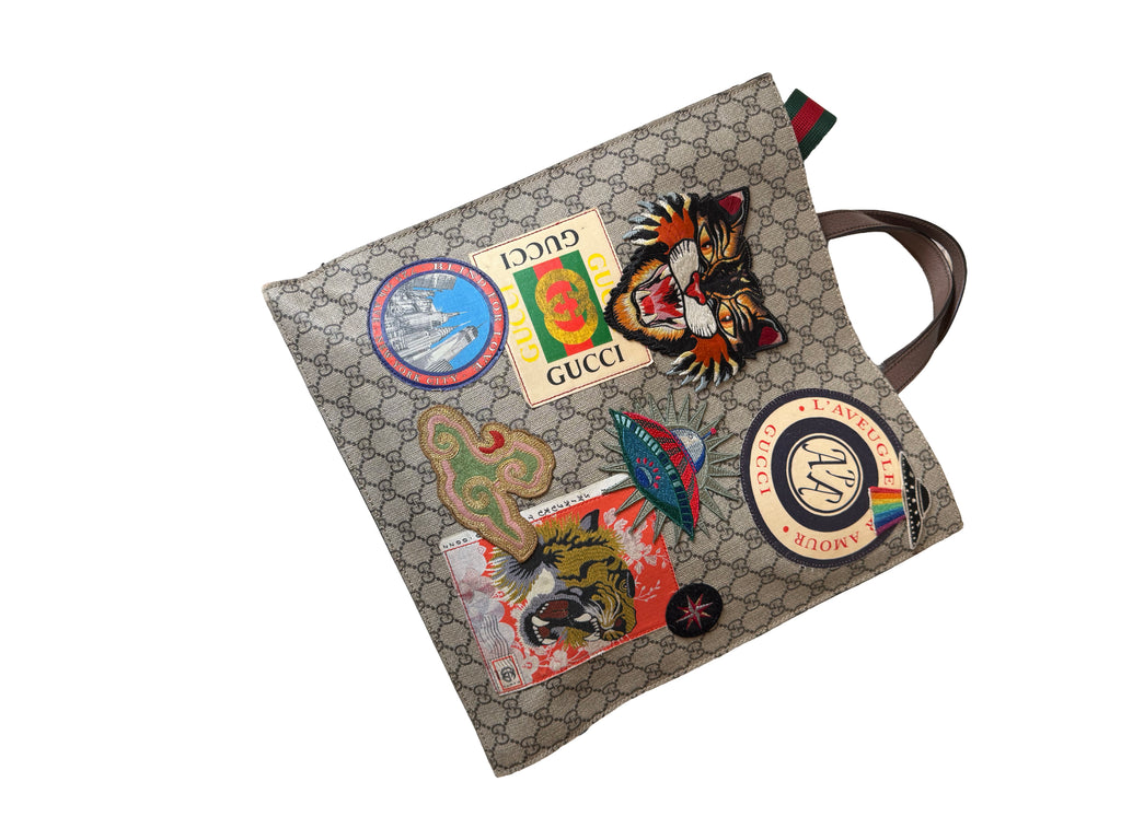 Gucci Gg Supreme Courrier Tote Bag Featuring A Variety Of Embroidered Appliques On The Gg Monogram Coated Canvas - Image 1