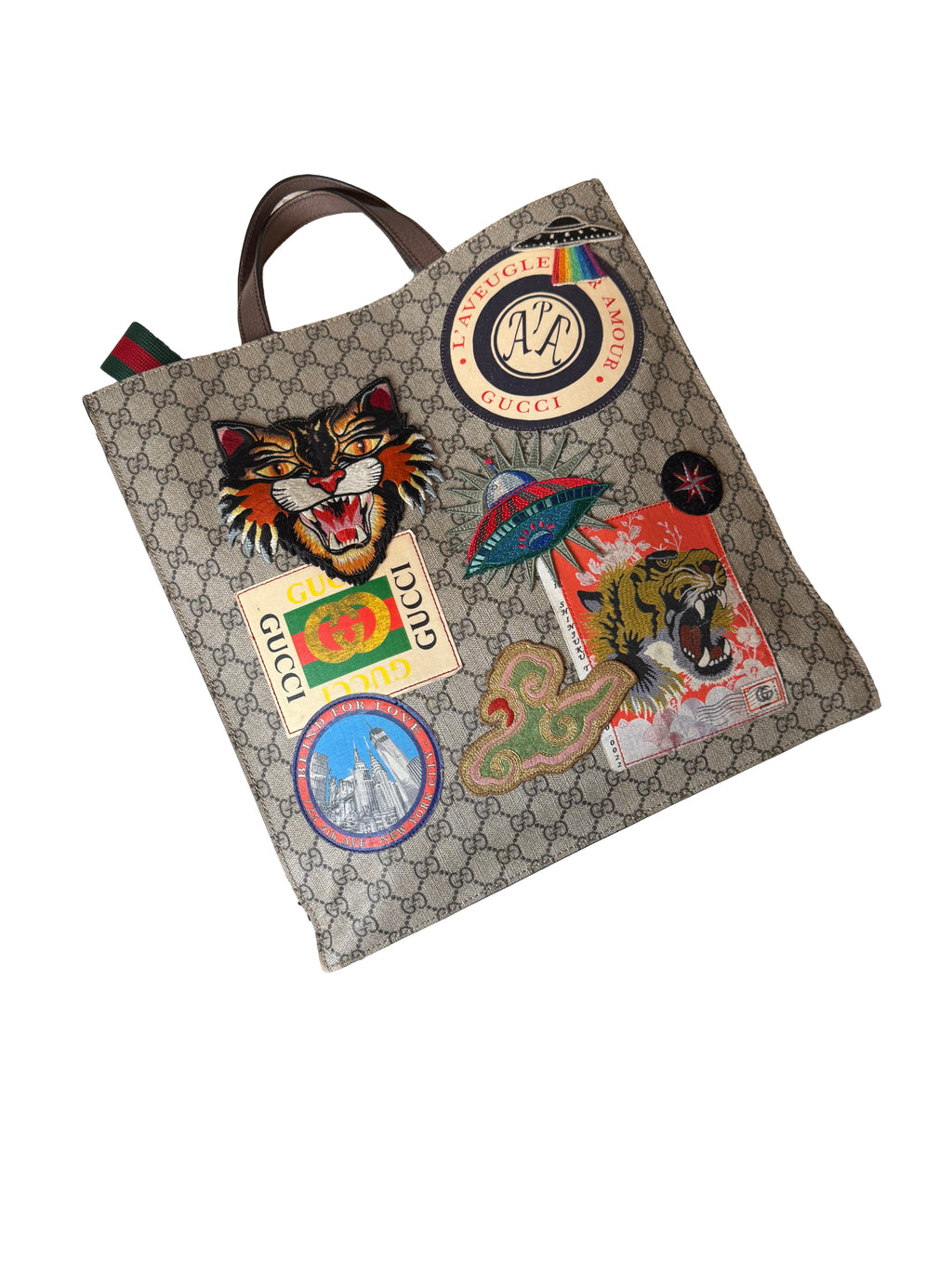 Gucci Gg Supreme Courrier Tote Bag Featuring A Variety Of Embroidered Appliques On The Gg Monogram Coated Canvas