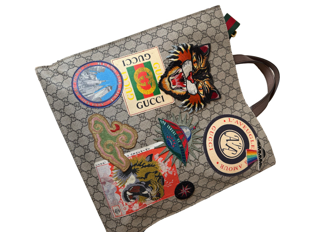 Gucci Gg Supreme Courrier Tote Bag Featuring A Variety Of Embroidered Appliques On The Gg Monogram Coated Canvas