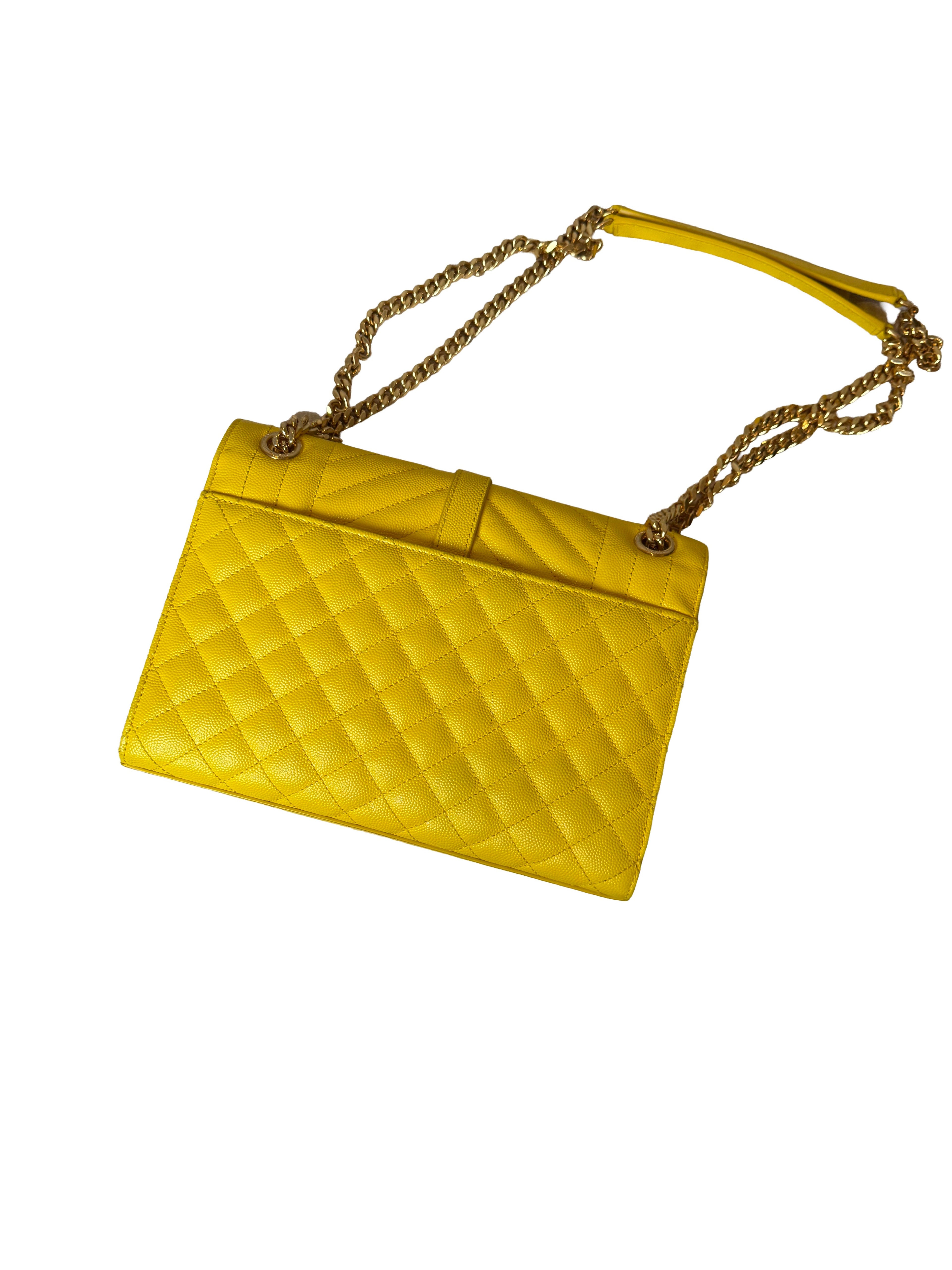 Yellow quilted handbag with a gold chain strap on a white background